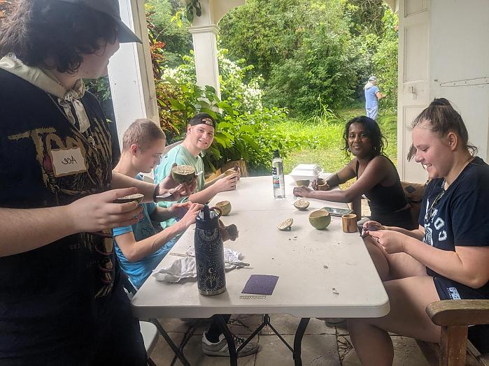 Group shot of students sitting at table outdoors