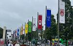 A row of colorful banners hanging from poles along a street in Galway, Ireland